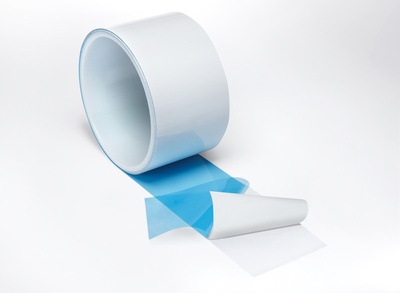 White roll of Thermally Conductive Tape, unrolling and unpeeling