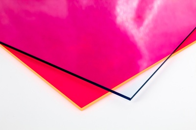 two overlapping pieces of acrylic plastic, in clear and red