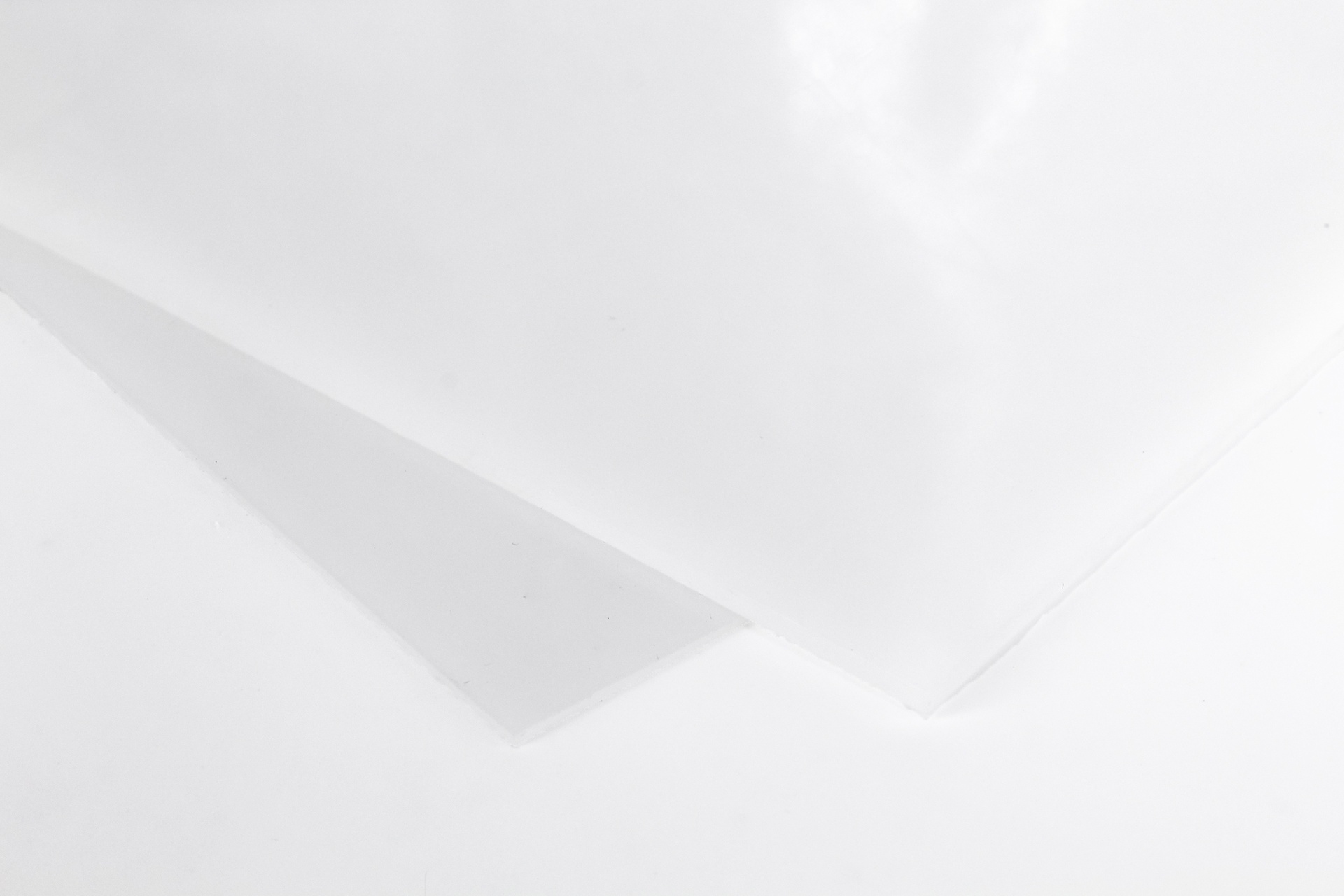 two pieces of white overlapping HIPs plastic